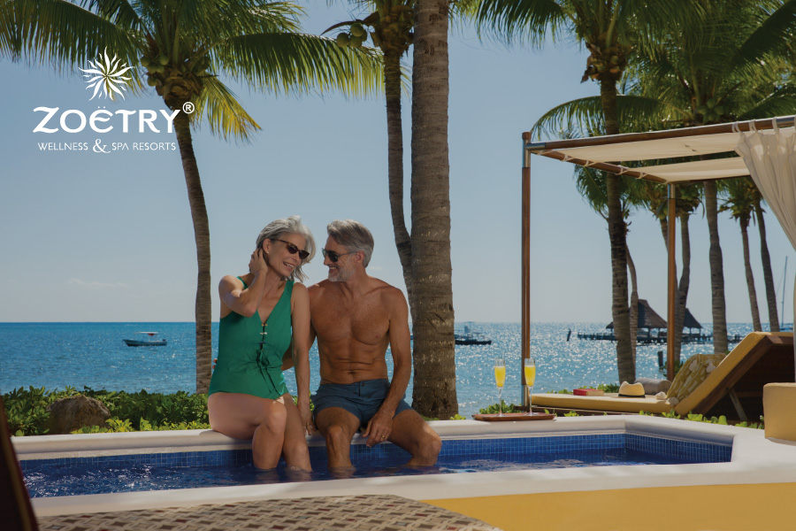 This is an image of a couple enjoying a sunny day at the pool at Zoëtry Wellness and Spa Resorts