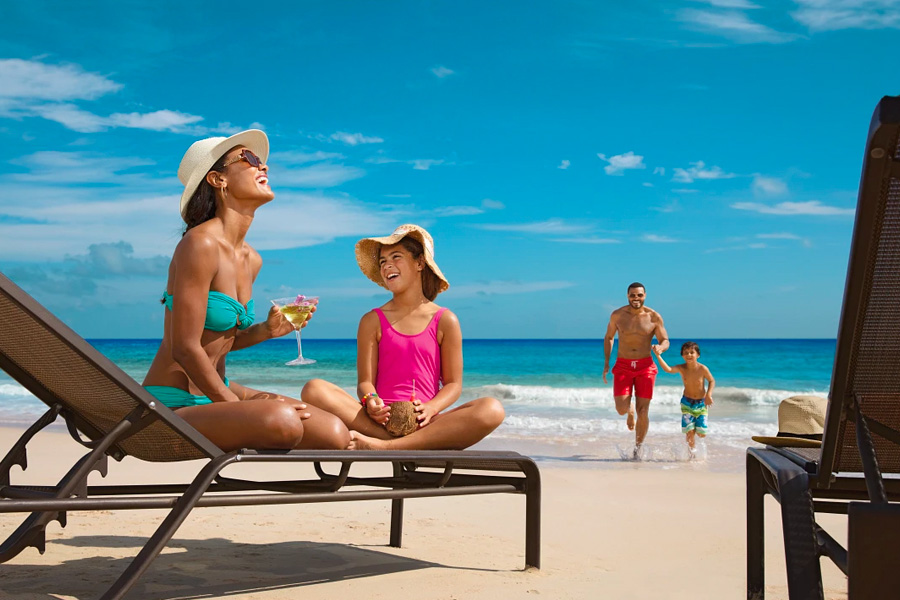 Family enjoying the sun and the beach at a Dreams Resort & Spa